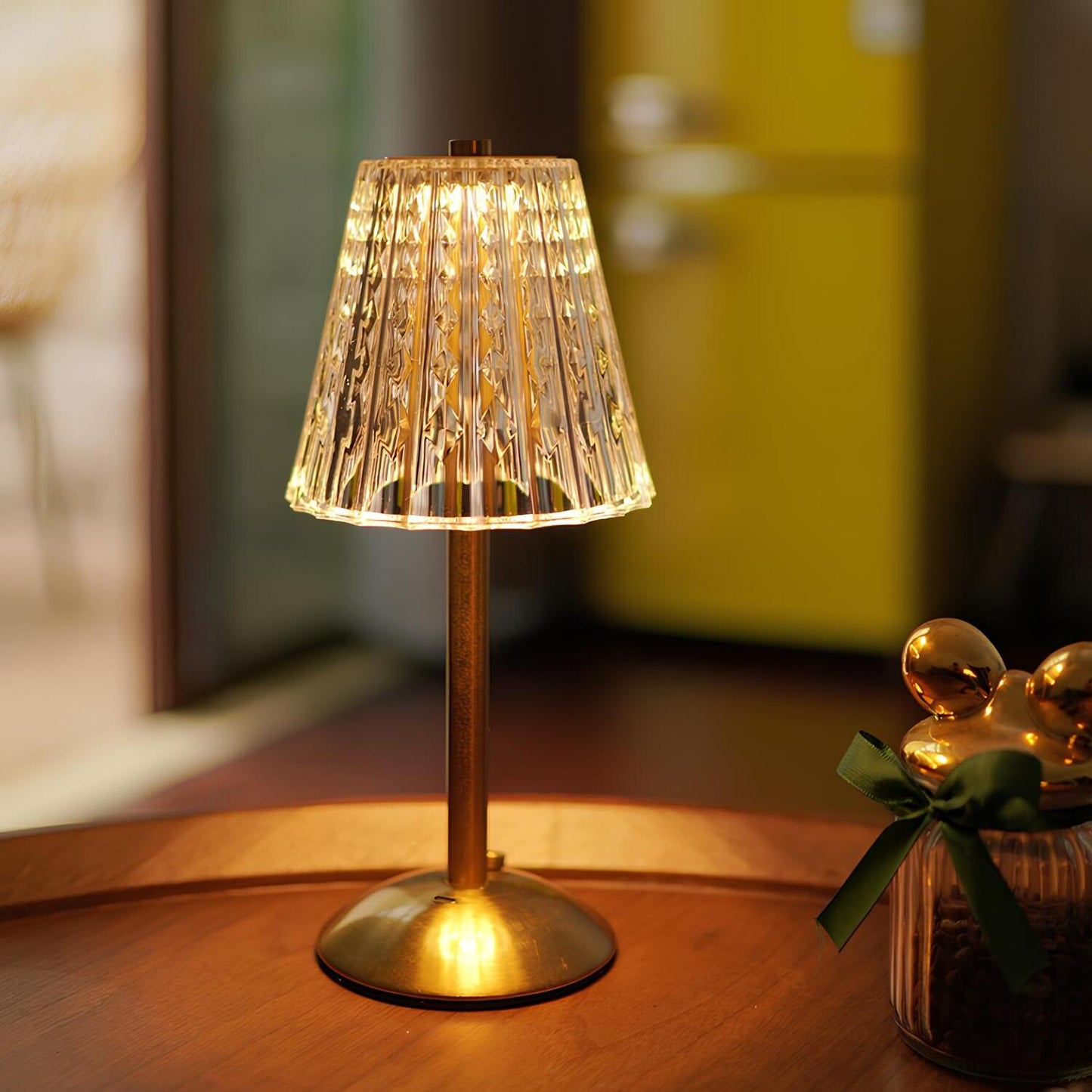 Decorative table lamp with a textured shade on a wooden surface.