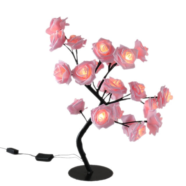 Decorative lamp with pink rose-shaped lights on a white background