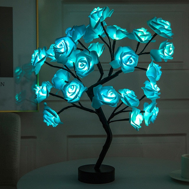 Decorative LED tree with blue roses on a dark background