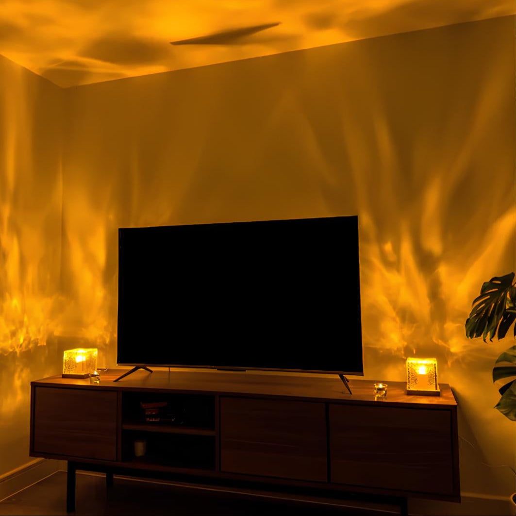 Large flat-screen TV on a wooden stand with decorative items in a dimly lit room.