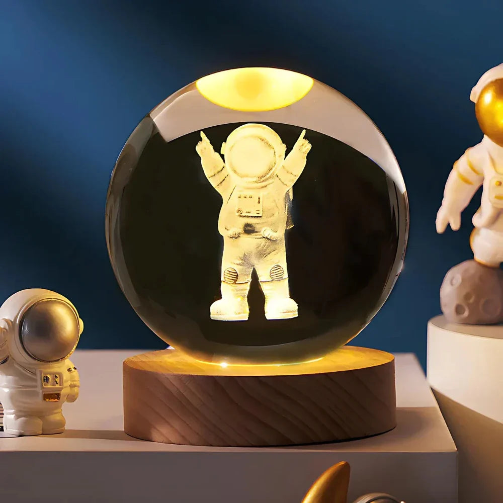Astronaut figure inside a transparent sphere on a wooden base with other astronaut figurines around.