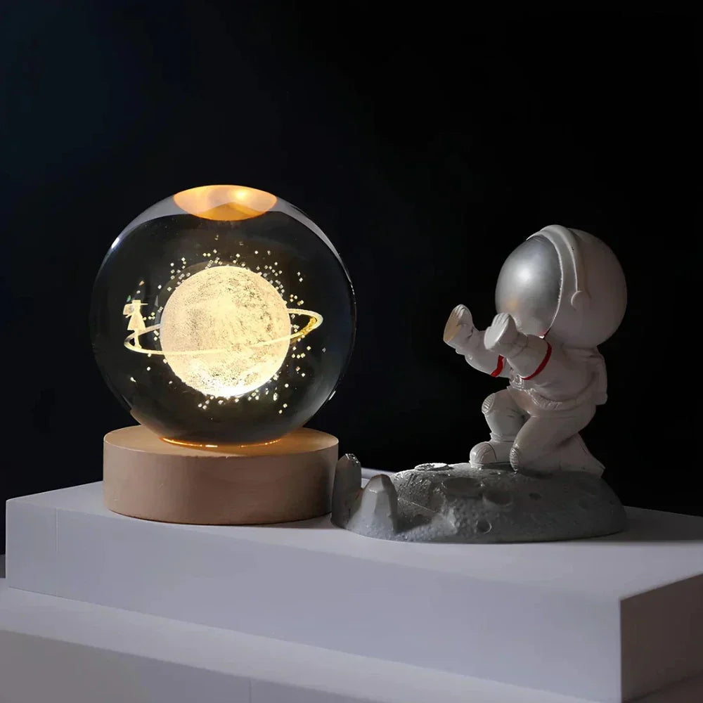 Decorative moon lamp with an astronaut figure on a dark background