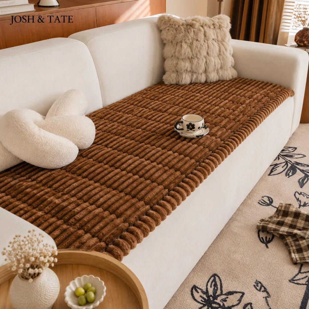 Josh & Tate - CozyLayer™ Plush Sofa Protector - Brown textured throw blanket on a white sofa with decorative pillows and a small table.