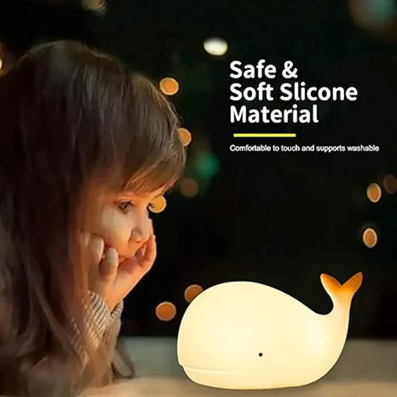 Child looking at a whale-shaped night light with text about safe and soft silicone material.