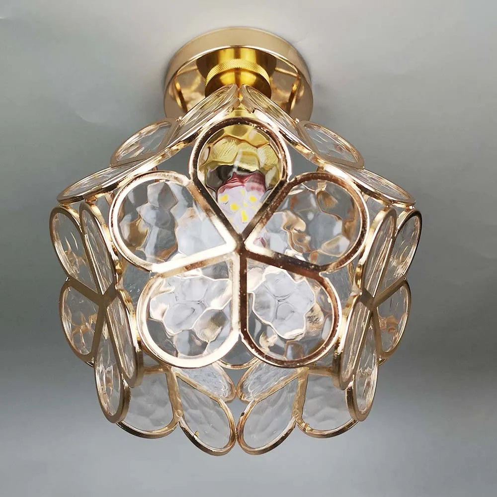 Decorative ceiling light fixture with gold and clear design on a gray background