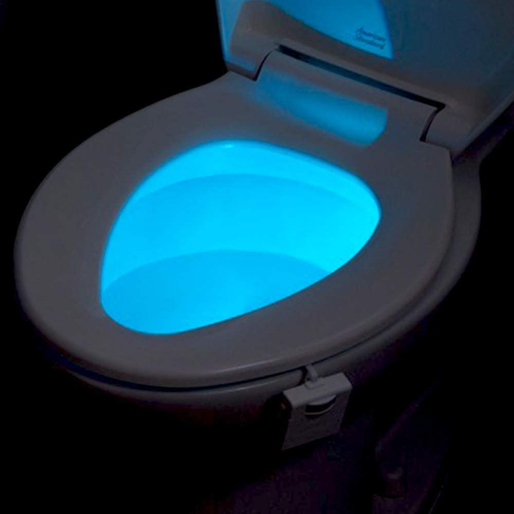 Toilet seat with a glowing blue light in the dark