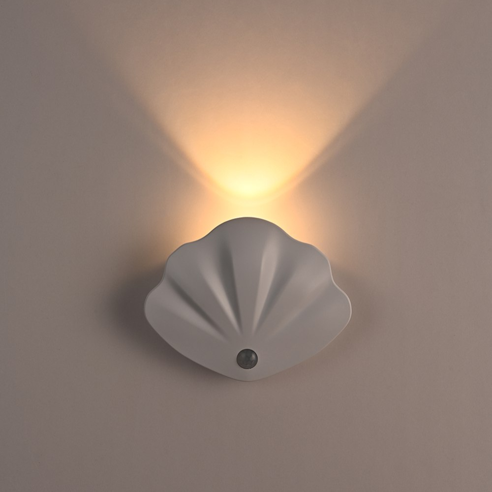 Shell-shaped wall light fixture on a plain wall