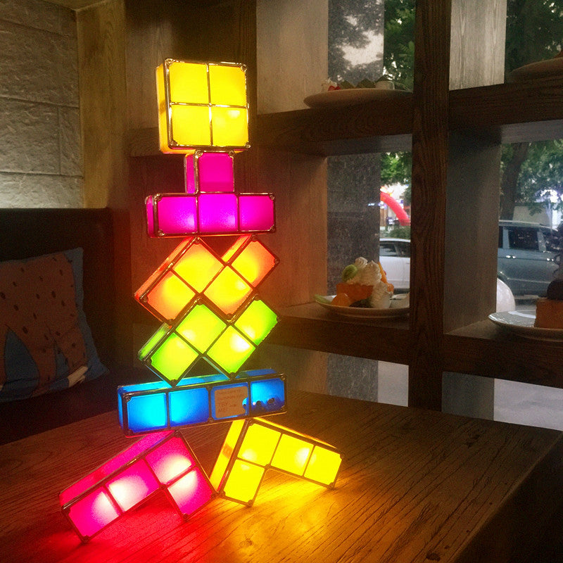 Colorful geometric lamp on a wooden table with a blurred background