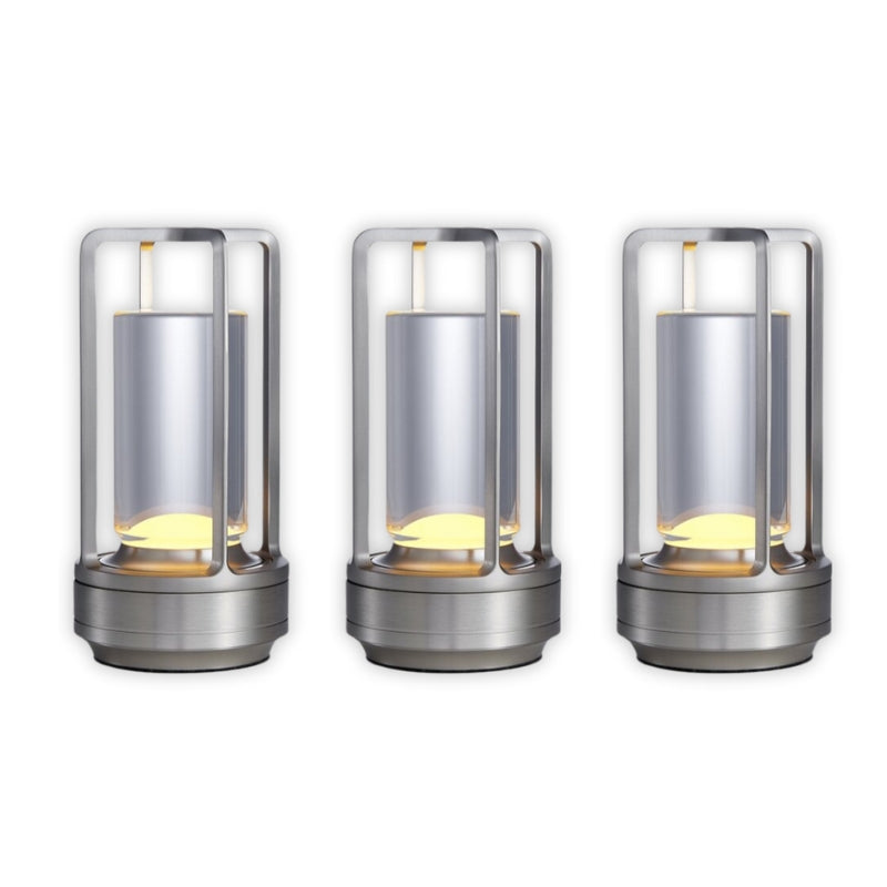 Three cylindrical metal lights with glass covers on a white background