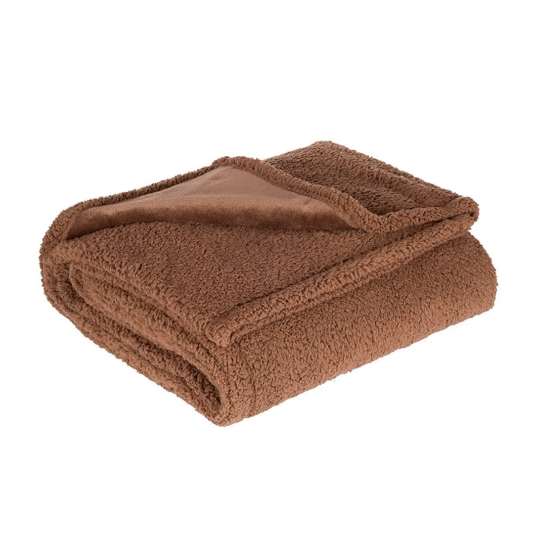 Folded brown blanket on a white background
