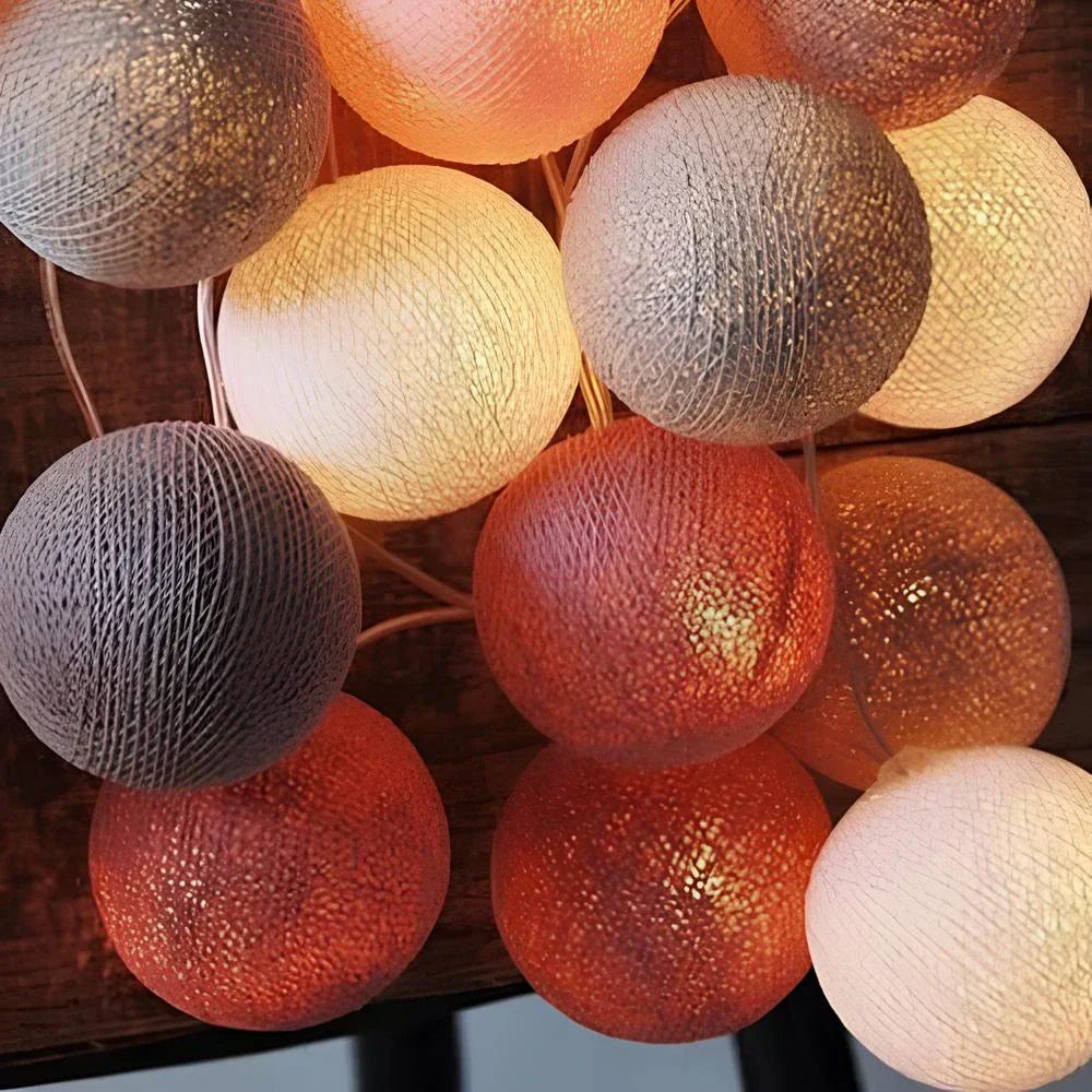 String of multicolored spherical lights on a wooden surface