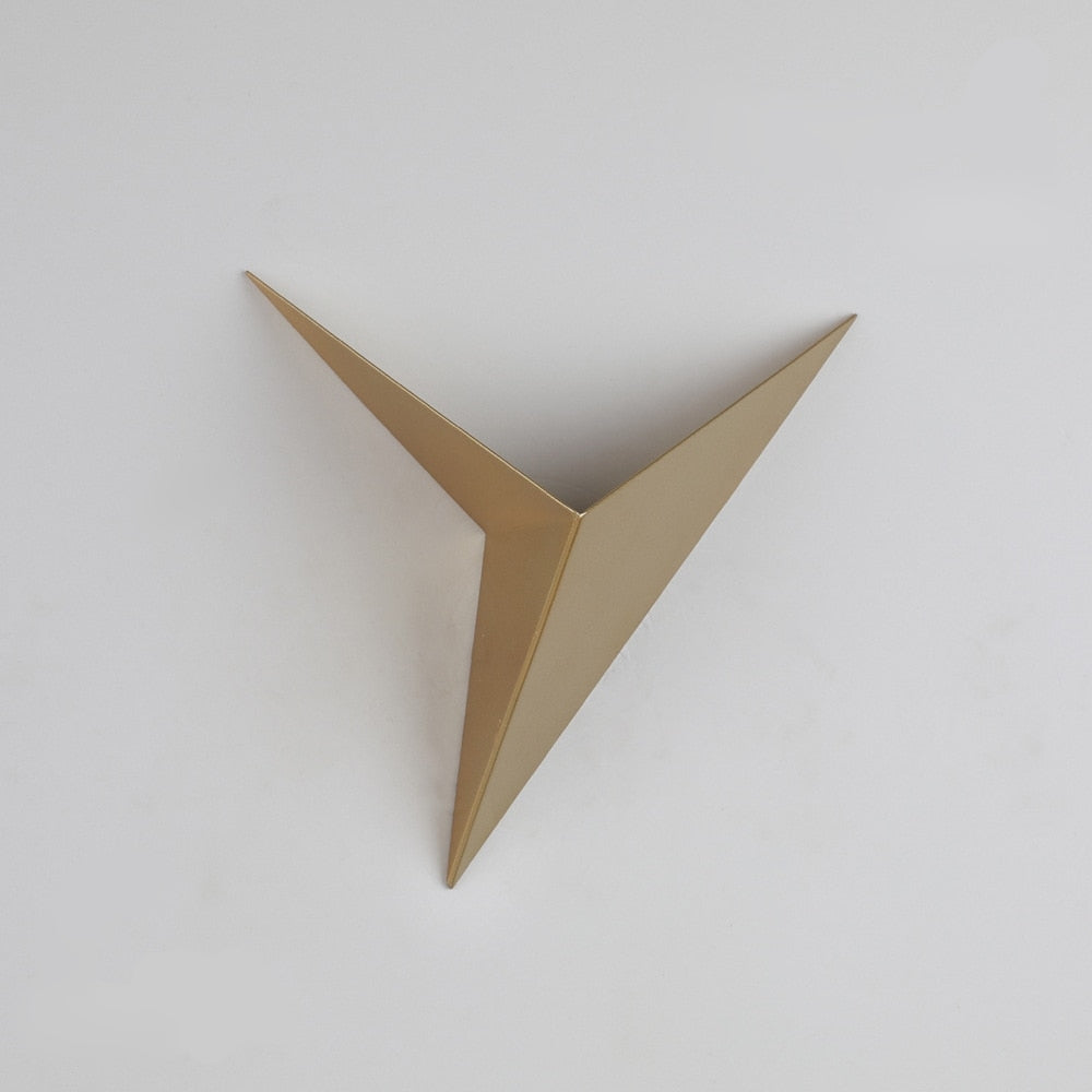 Gold metallic triangle wall art on a white background