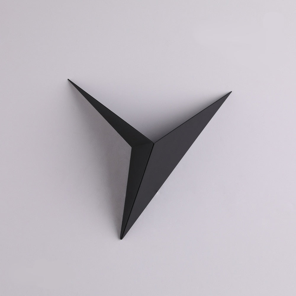 Black geometric wall art on a light gray background