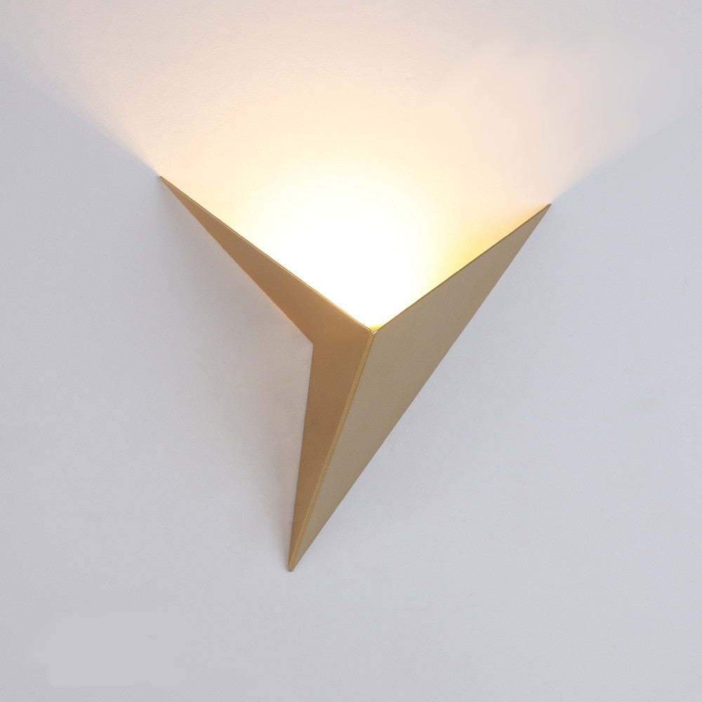 Triangular wall light fixture on a white background