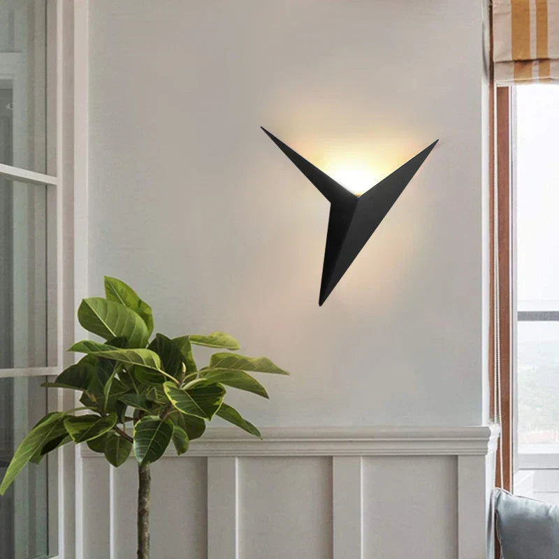 Modern wall sconce with a plant on a white wall