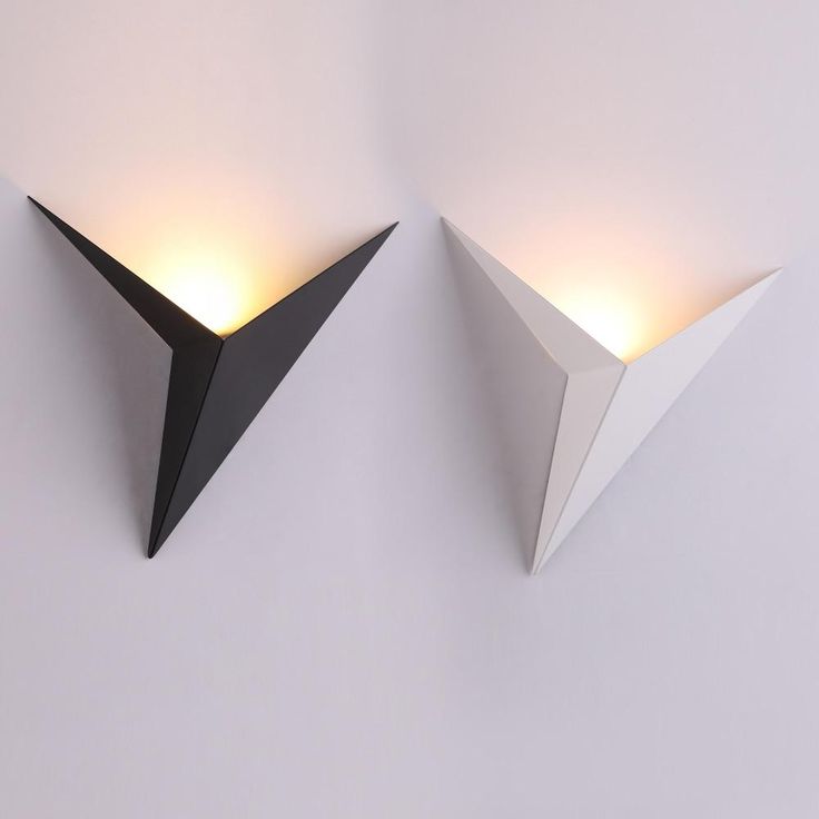 Modern wall lights with geometric design on a white wall