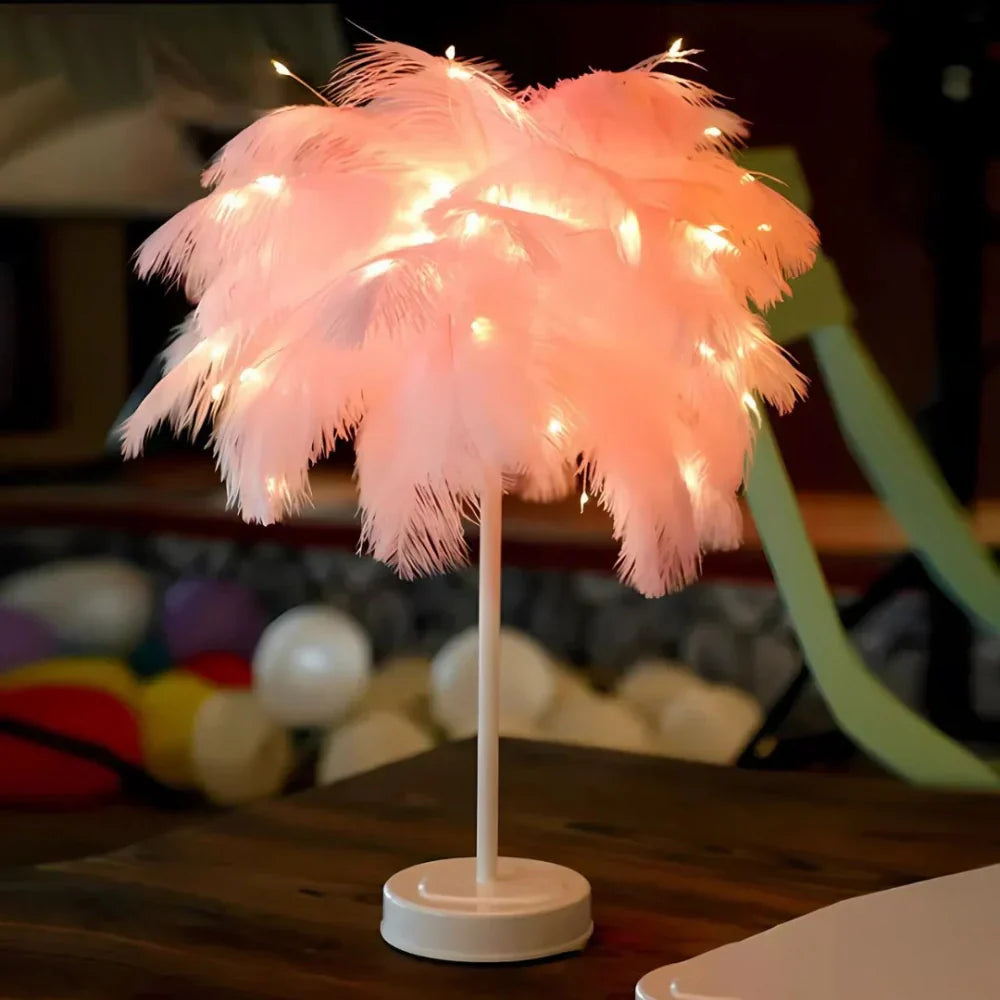 Pink feathered lamp with string lights on a wooden surface