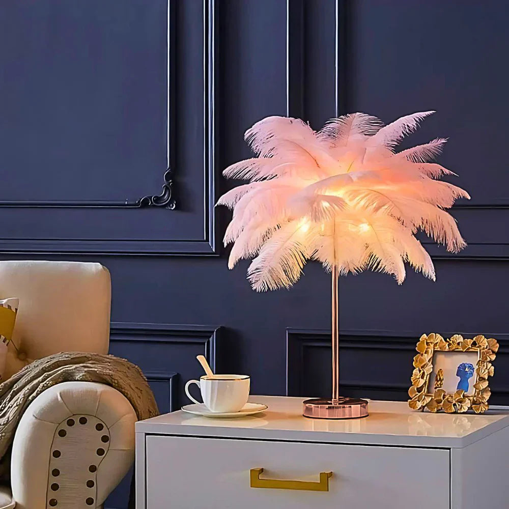 Feathered lamp on a nightstand with a cup and saucer, against a dark blue wall.