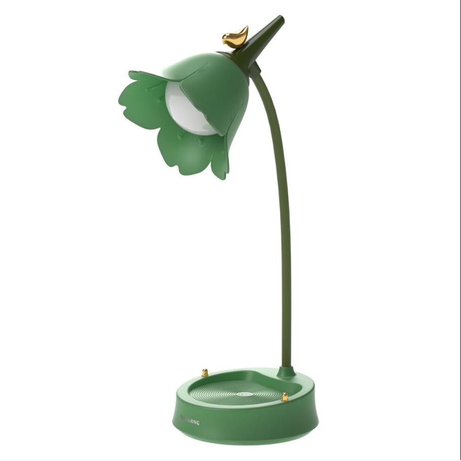 Green desk lamp shaped like a flower on a white background