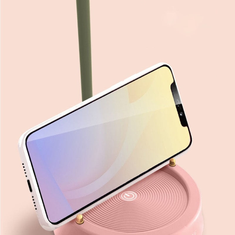 Smartphone on a pink stand with a gradient screen on a light pink background