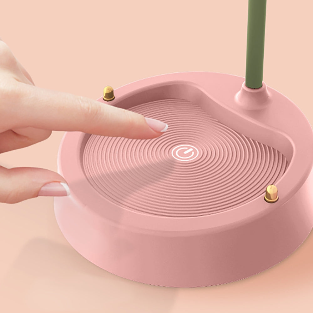 Pink electronic device with a hand interacting with it on a pink background