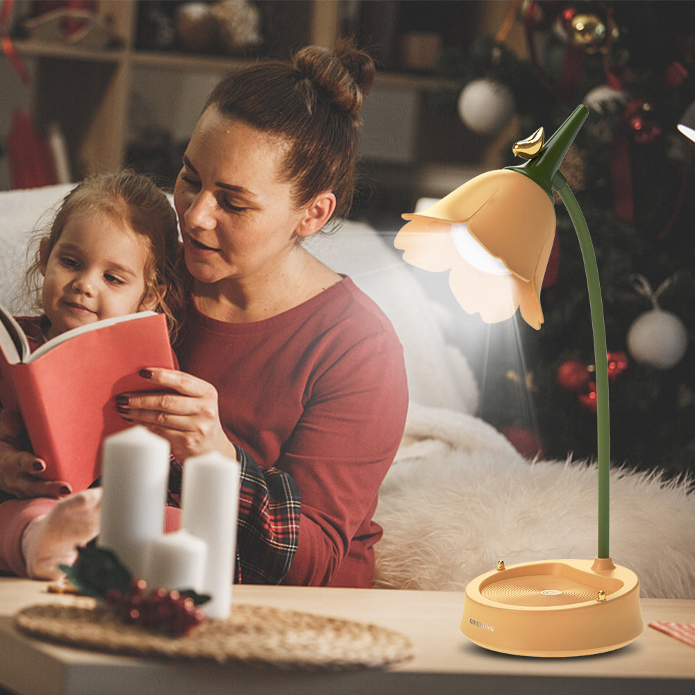 Woman and child reading a book with a lamp on a table in a cozy room.