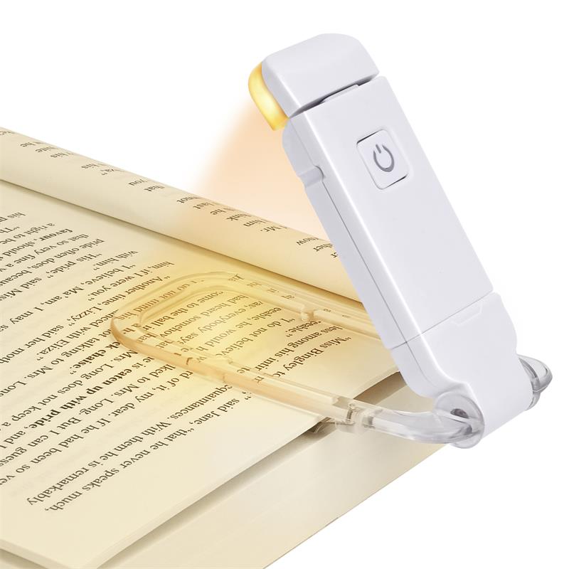 Reading lamp illuminating a book on a white background