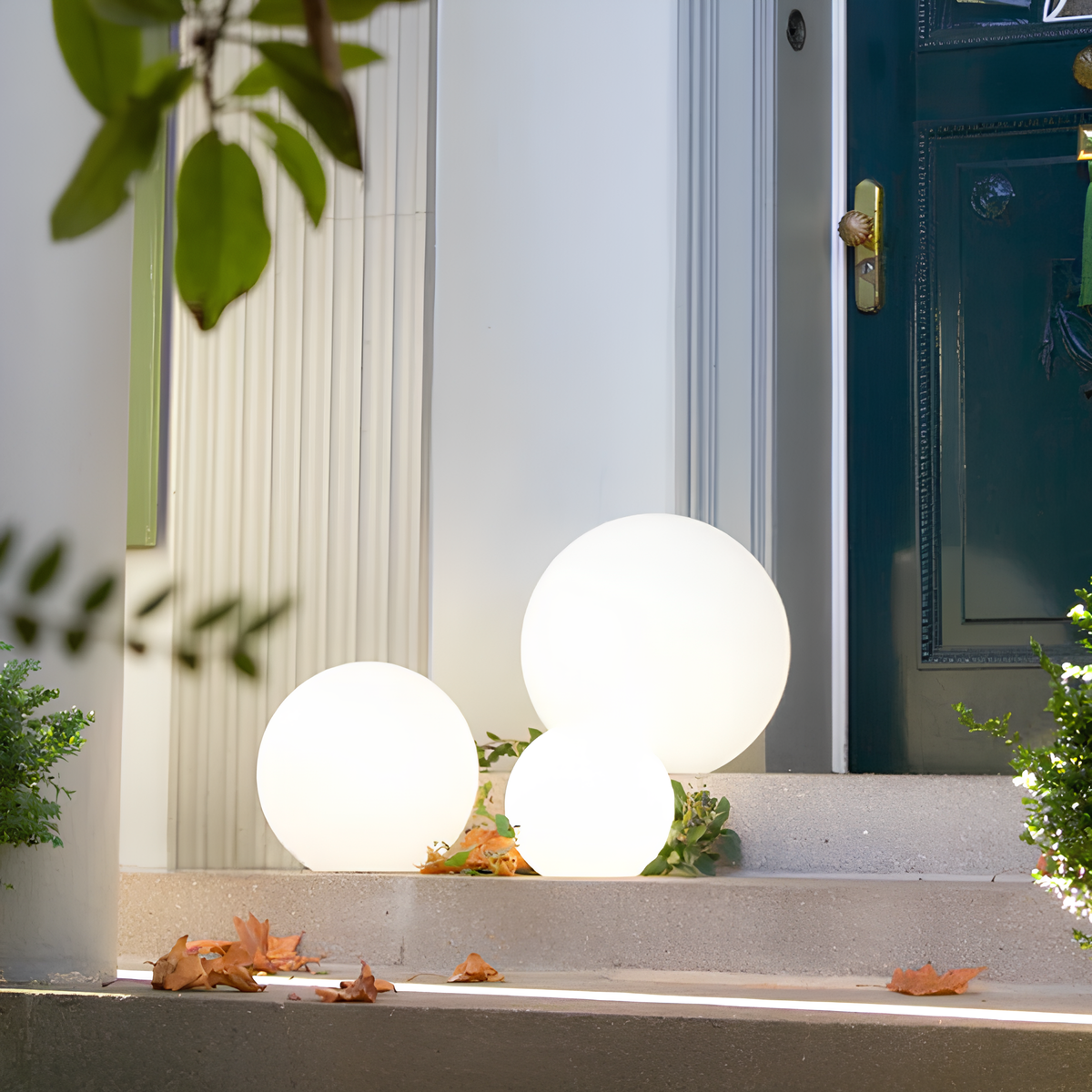 Three spherical white lights on a doorstep with a door in the background