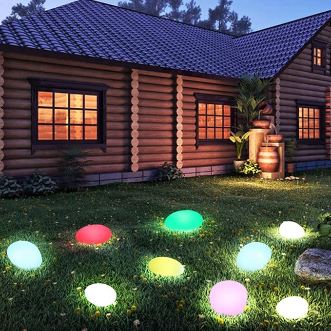 Colorful LED lights on grass in front of a log cabin