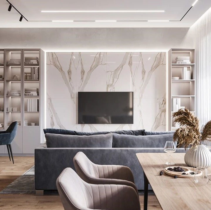 Modern living room with marble wall, gray sofa, and wooden coffee table.