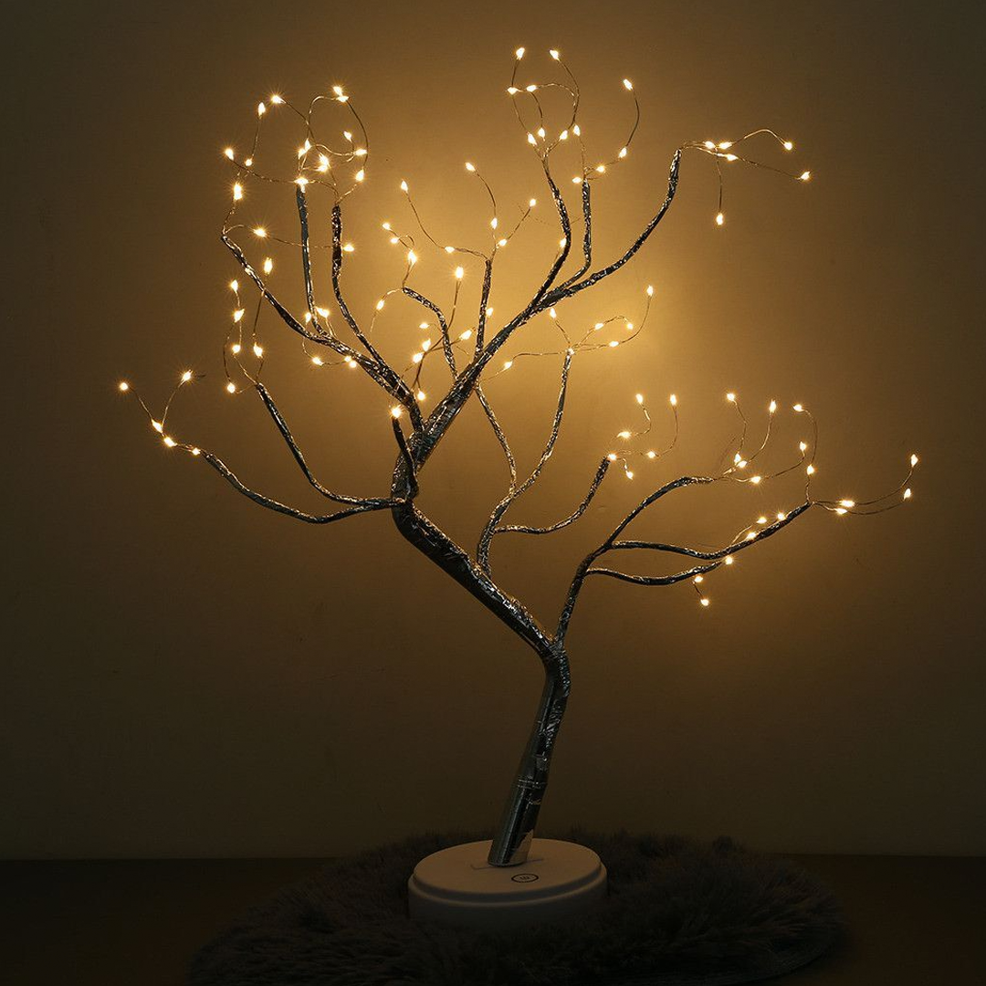 Decorative tree with string lights against a dark background