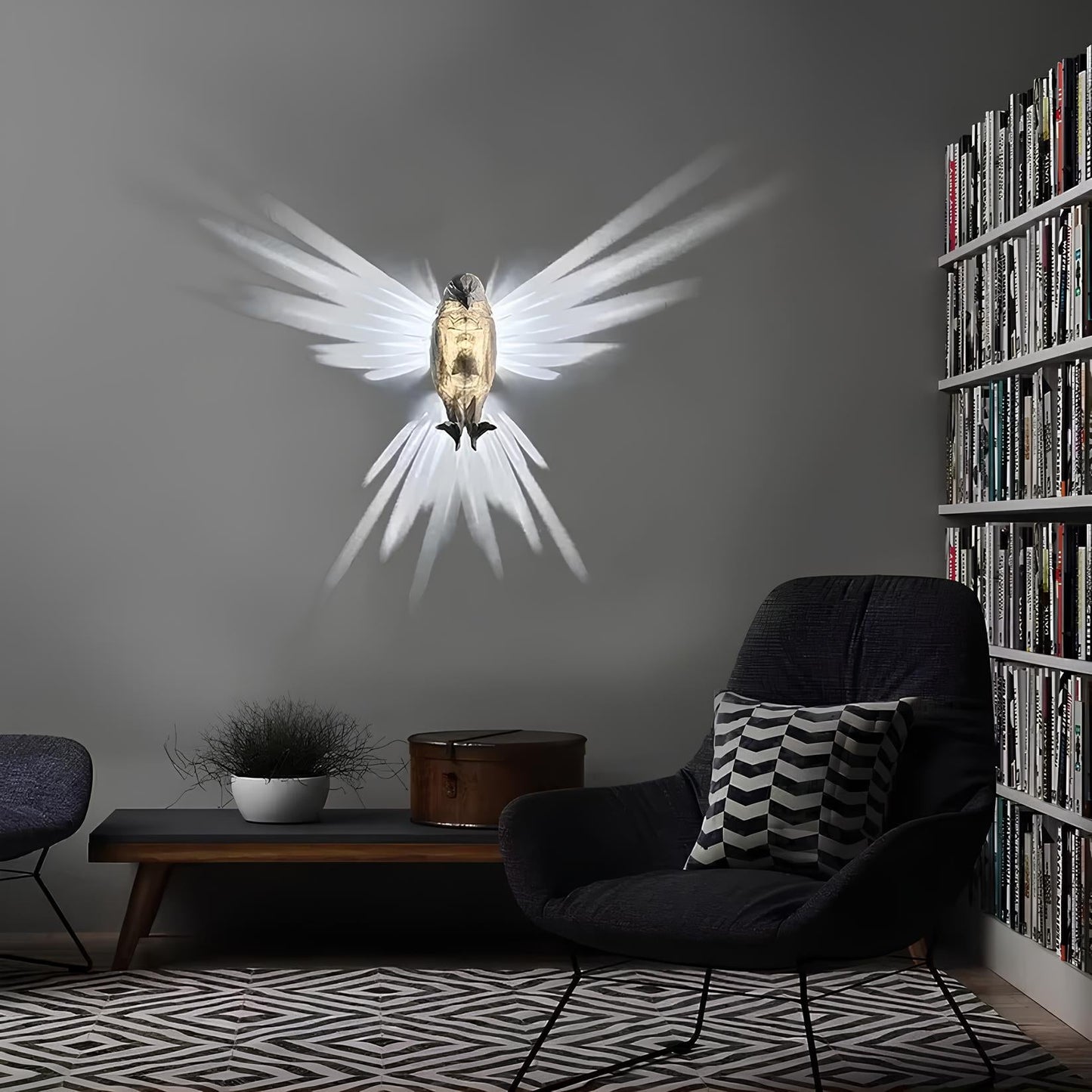 Modern living room with a wall-mounted angel sculpture, dark armchair, and bookshelf.