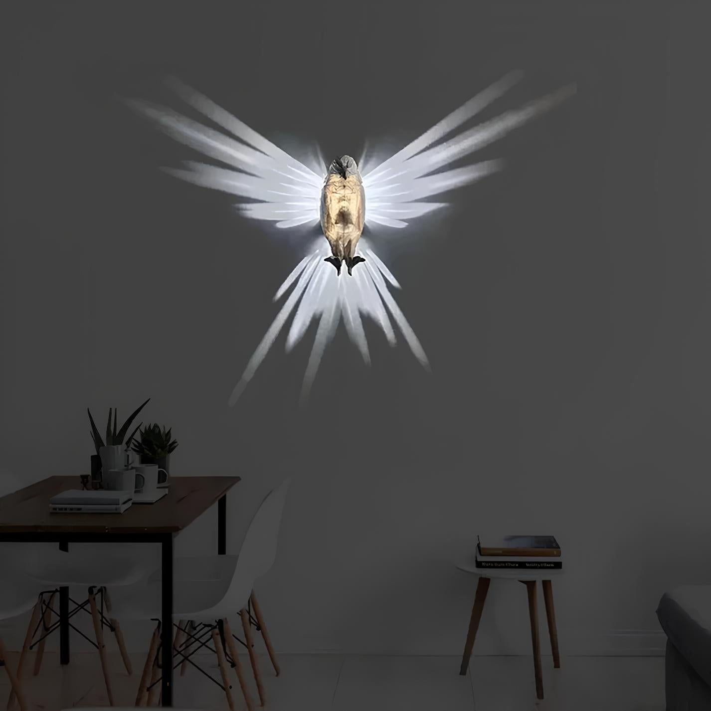 Decorative wall light shaped like a bird with spread wings on a dark wall.