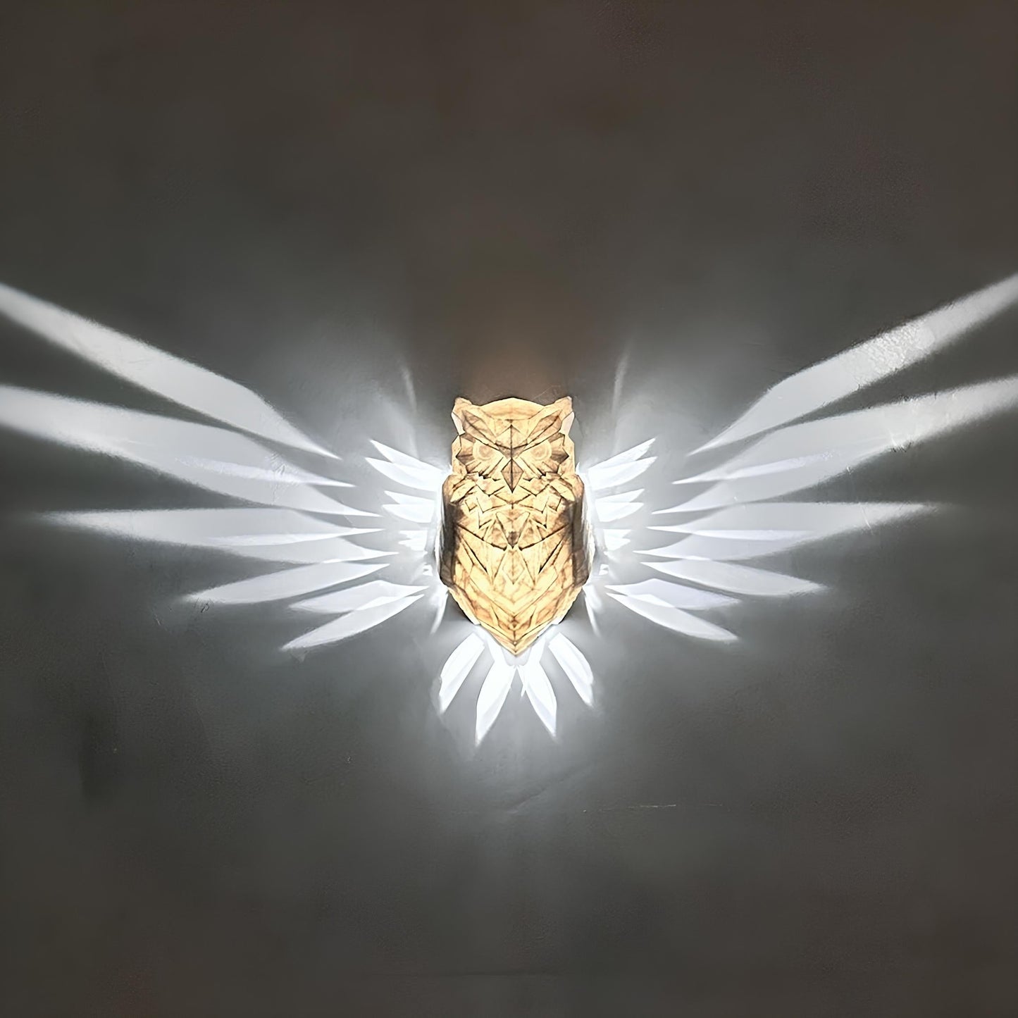 Gold owl-shaped object with a dark background