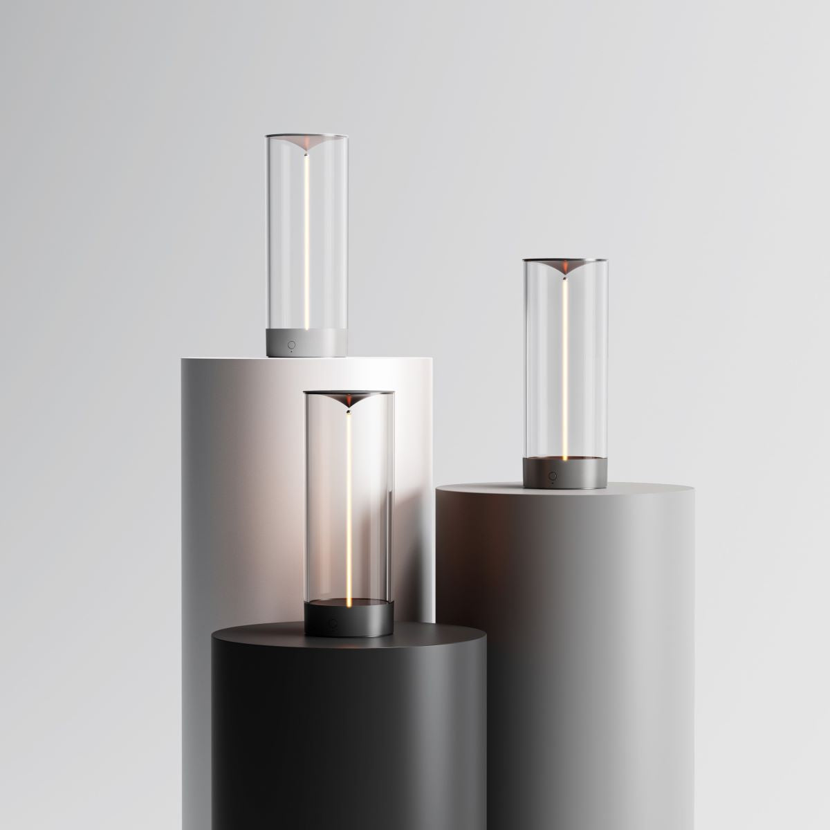 Modern outdoor lights on cylindrical stands against a light gray background