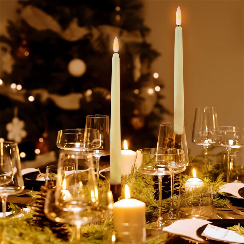 Dining table set with candles and glasses, Christmas tree in the background
