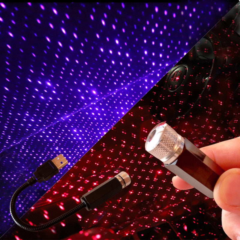 Laser pointer with star light projector and USB cable on a dark background