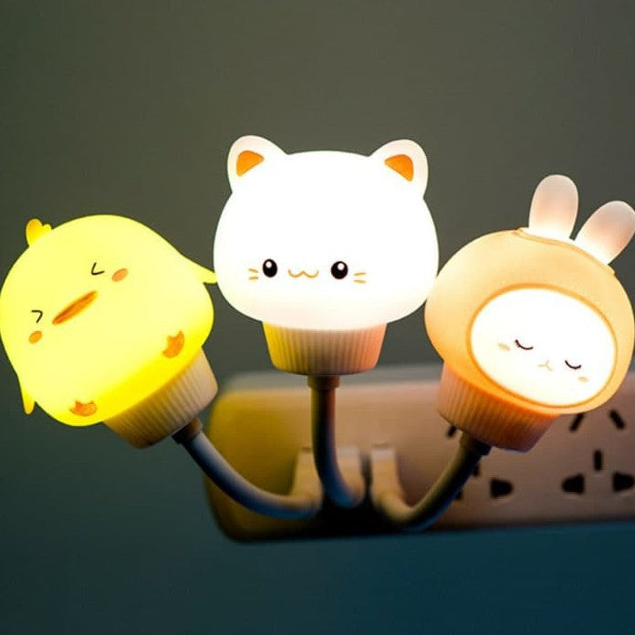 Three cartoon-style night lights shaped like animals on a dark background