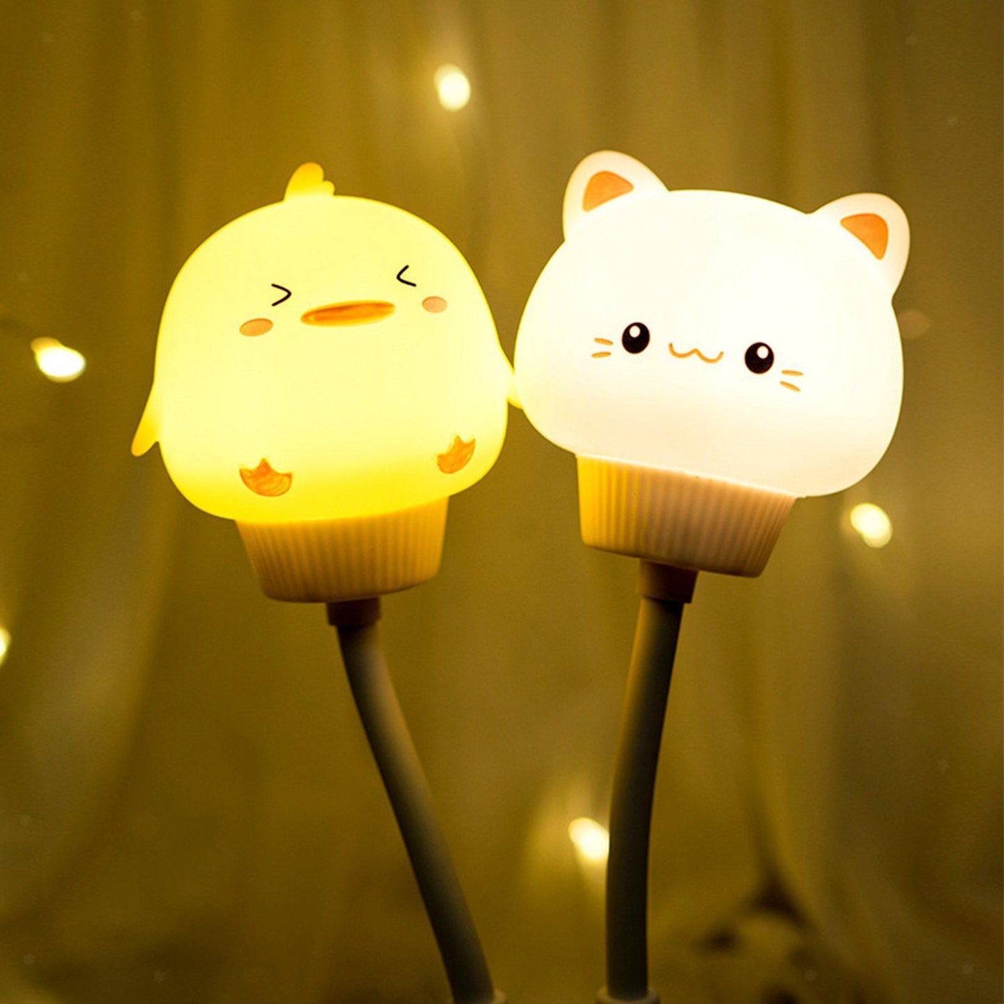 Two cute lamp characters, one resembling a chick and the other a cat, against a warm glow background.