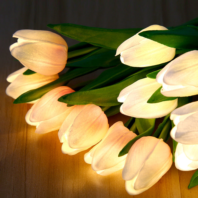 Bouquet of illuminated tulips on a wooden surface