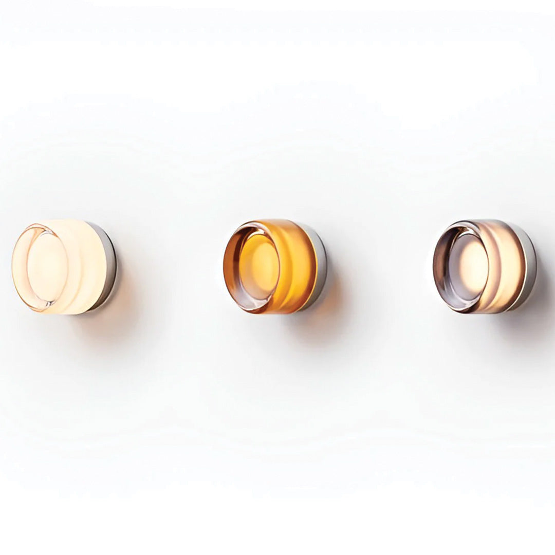 Three wall-mounted lights with different color temperatures on a white background