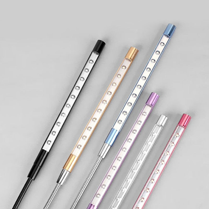 Set of decorative pens with metallic sheen on a gray background