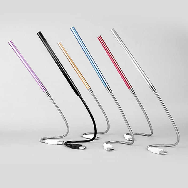 Set of colorful metal straws on a light gray background