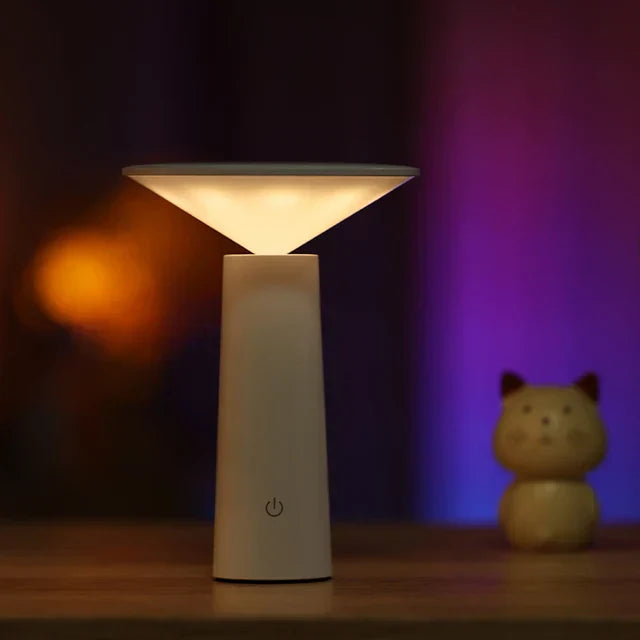 White lamp on a wooden surface with a blurred background