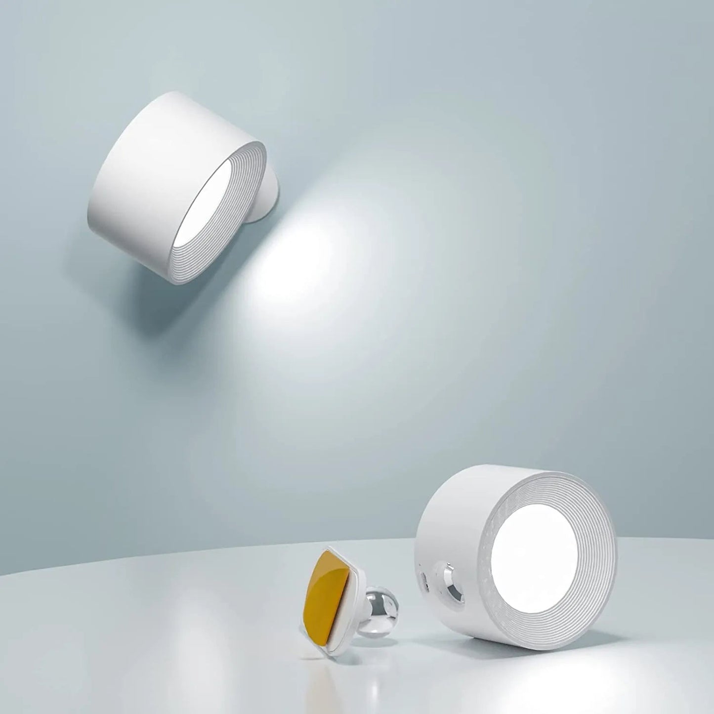 Two white wall lights on a light gray background