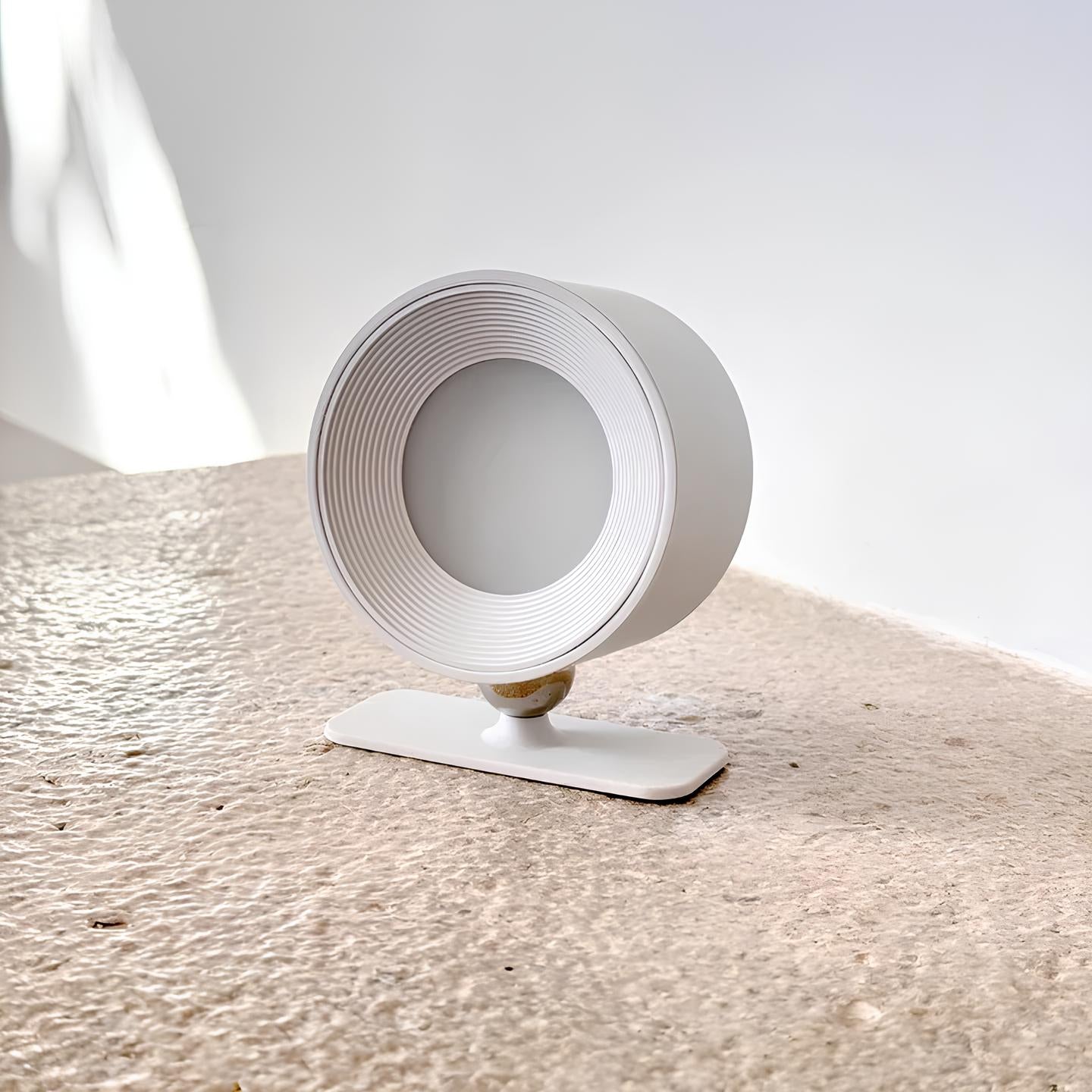 White cylindrical object on a textured surface with a light gray background