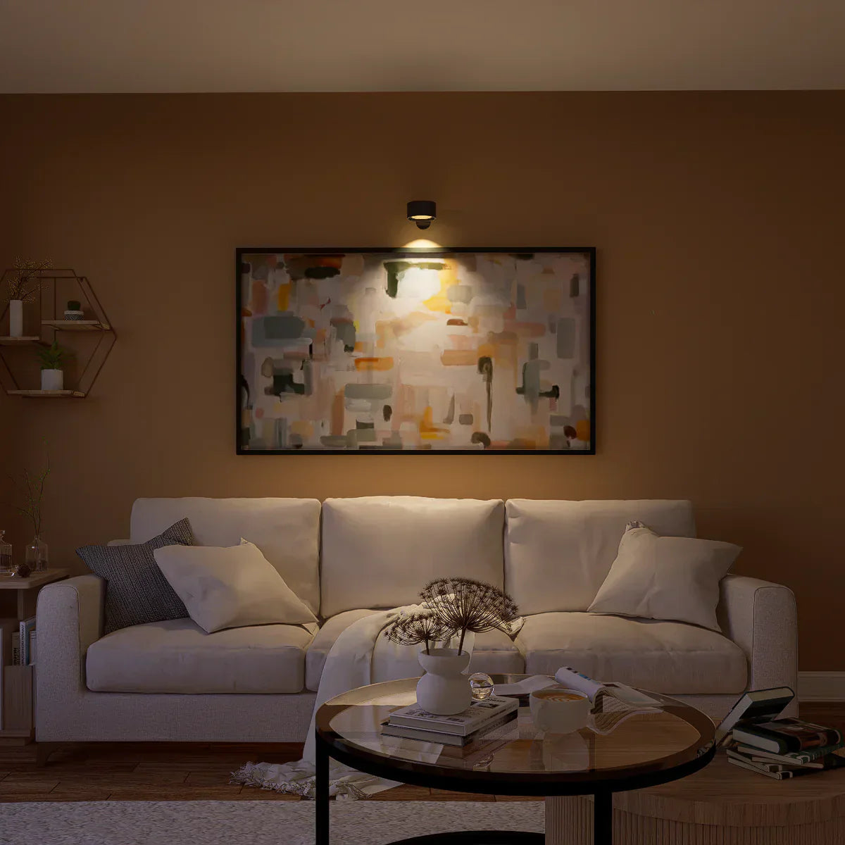 Cozy living room with a white sofa, coffee table, and wall art.