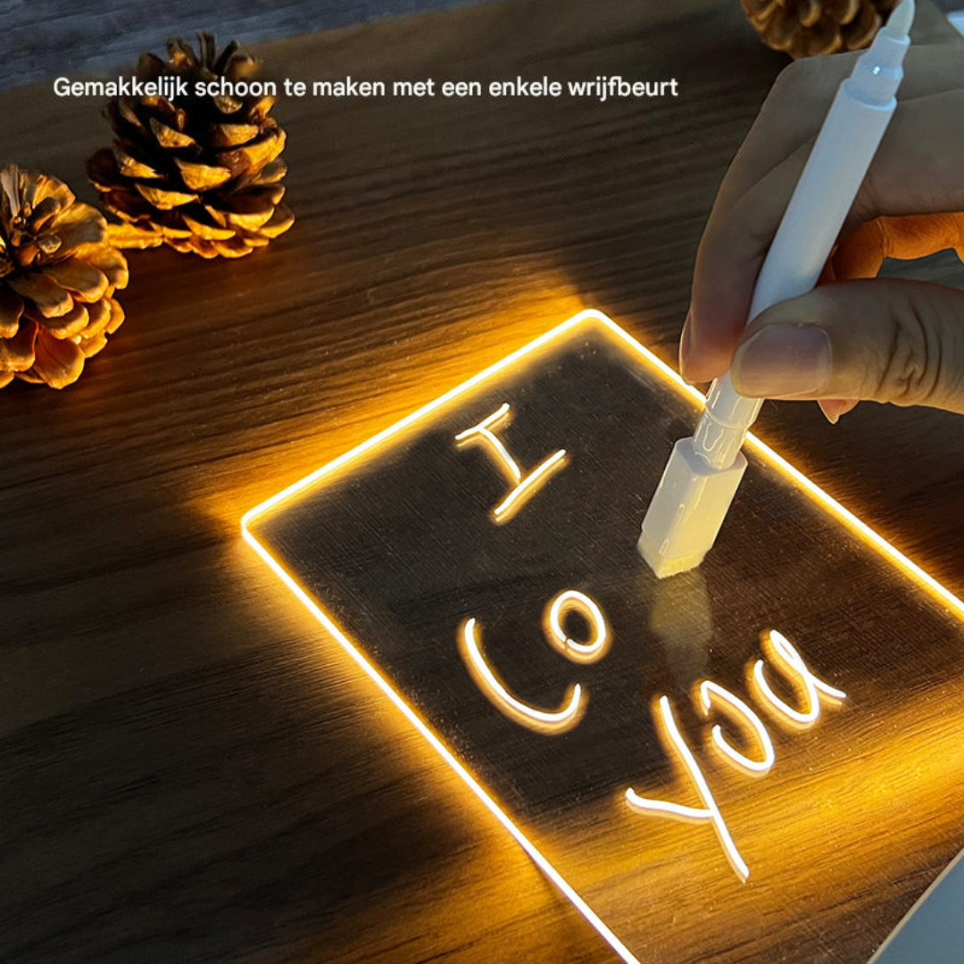 Neon sign with 'I Love You' on a wooden surface with pine cones.
