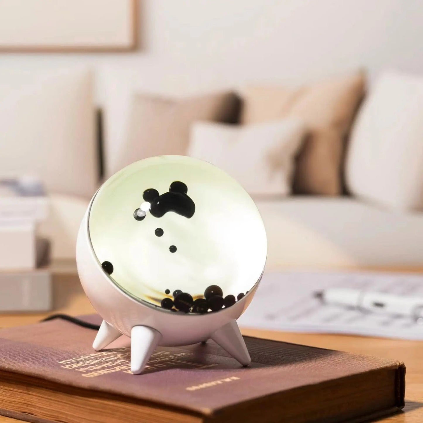 Decorative night light with cartoon character on a book in a living room setting