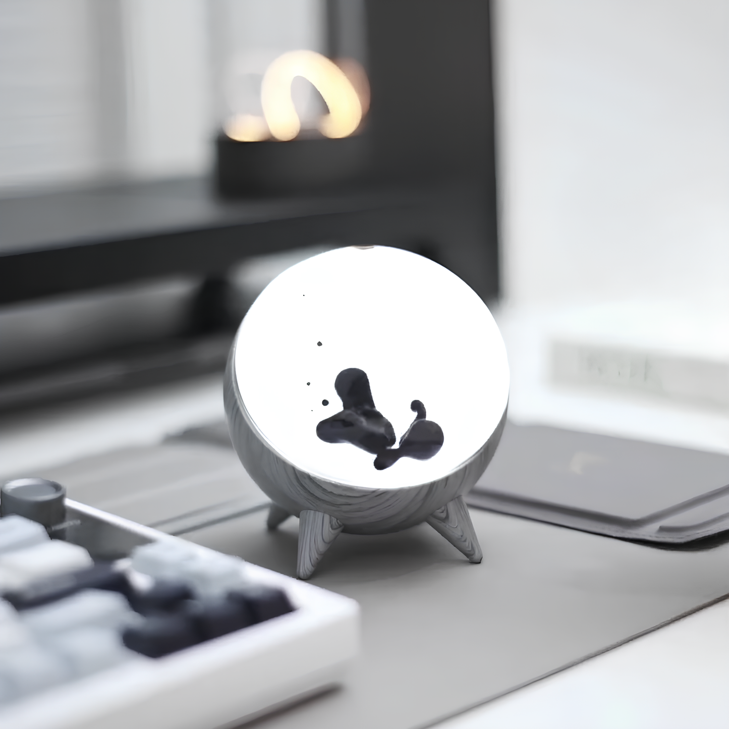 Small round white object with black design on a metallic surface